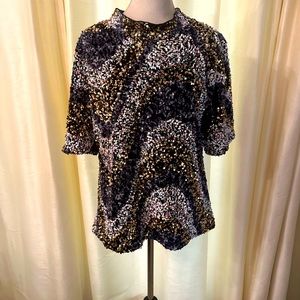 Multi-colored sequin top perfect to dress up with leather, velvet or denim.